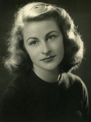Black and white portrait photograph of a young woman with wavy hair, from the Genevieve Lyons archive