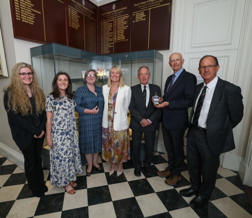 Speakers, donors and RCSI senior management standing in front of a display case at the Hayes, Conyngham and Robinson archive collection event