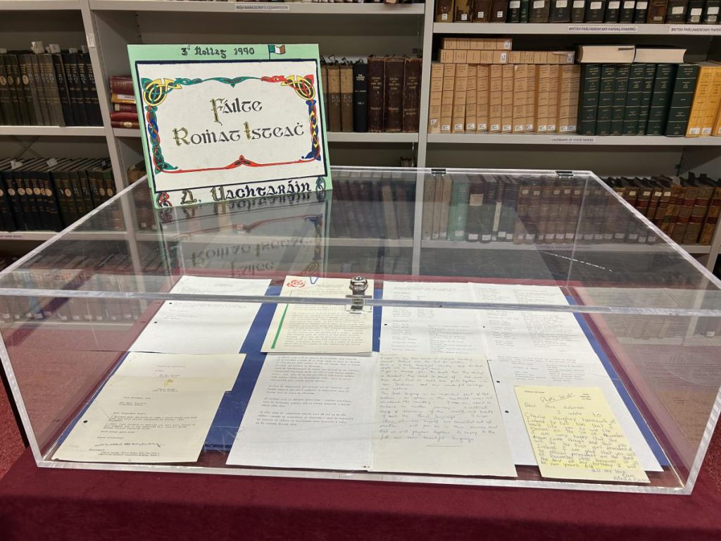 Display case of letters and cards from the Mary Robinson archive, beneath a hand-lettered card reading Fáilte Romhat Isteach