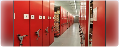 Rows of red mobile shelving units in a records store