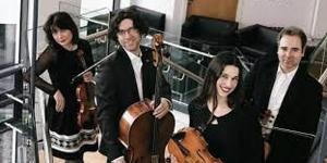 Four musicians posing with violin, viola and cello